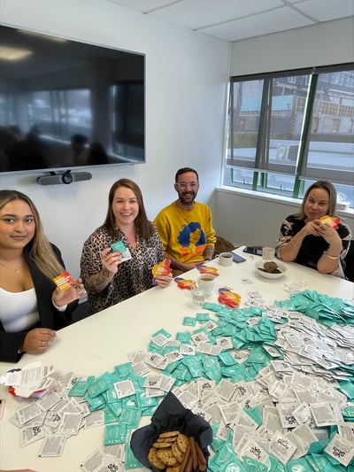 Perceptive team members packing condoms for the NZ Aids Foundation